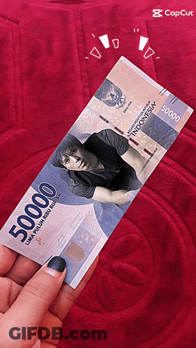 A Person Is Holding A 50000 Indonesian Bill GIF