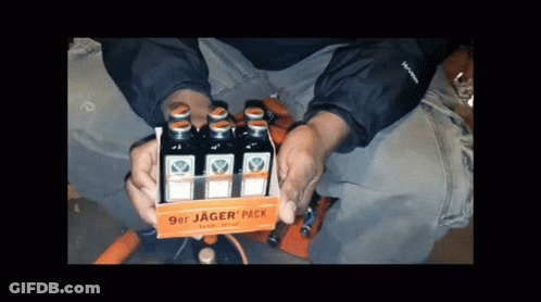 A Person Is Holding A 9Er Jager Pack Of Liquor GIF