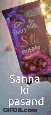 A Person Is Holding A Bag Of Cadbury Silk Bubble Candy GIF