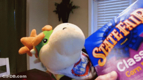 A Person Is Holding A Bag Of State Fair Class Corn GIF