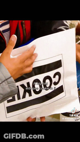 A Person Is Holding A Bag That Has The Word Cookie On It GIF