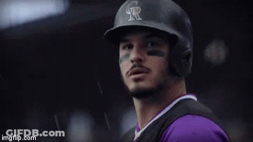 A Person Is Holding A Baseball Glove With The Name Nolan On It GIF