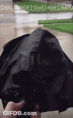 A Person Is Holding A Black Umbrella With The Words Challenge God Level Impo On The Bottom GIF