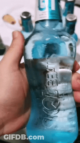 A Person Is Holding A Blue Bottle Of Aquafina GIF