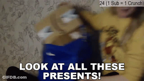 A Person Is Holding A Blue Box With The Words Look At All These Presents Written On It GIF