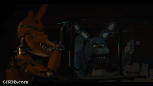 A Person Is Holding A Blue Object In Their Hand In A Dark Room GIF