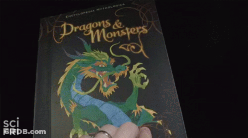 A Person Is Holding A Book With A Picture Of A Plant On It . GIF