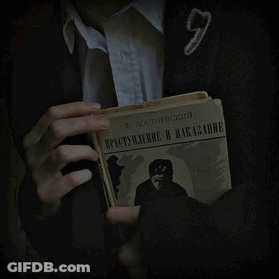 A Person Is Holding A Book With A Picture Of A Shield On It GIF
