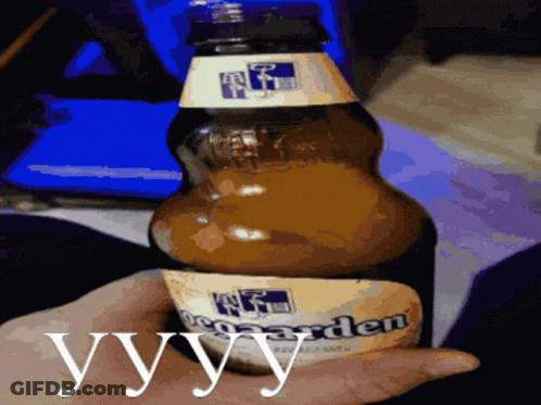 A Person Is Holding A Bottle Of Beer With The Word Yvy On It GIF