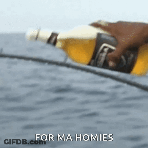 A Person Is Holding A Bottle Of Beer With The Words For Ma Homies Behind Them GIF