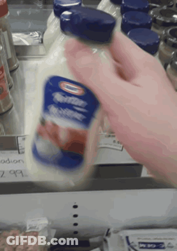 A Person Is Holding A Bottle Of Buttermilk GIF