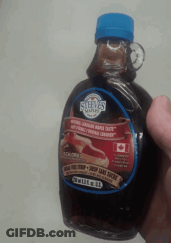 A Person Is Holding A Bottle Of Steeva 'S Maple Syrup In Their Hand GIF