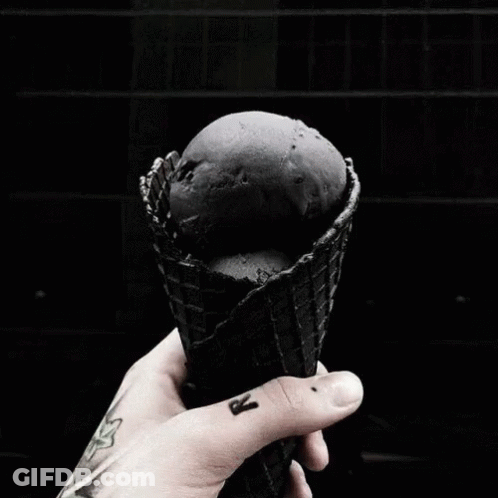 A Person Is Holding A Bouquet Of Black Roses In Their Hands . GIF
