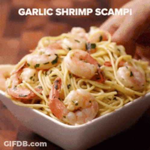 A Person Is Holding A Bowl Of Garlic Shrimp Scampi Pasta GIF