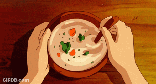A Person Is Holding A Bowl Of Soup With A Spoon GIF