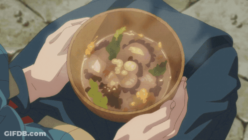 A Person Is Holding A Bowl Of Soup With Vegetables GIF