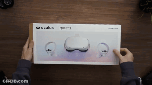 A Person Is Holding A Box That Says Oculus Quest 2 GIF