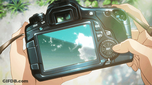 A Person Is Holding A Camera With The Off And On Buttons On The Back GIF