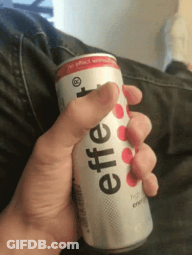 A Person Is Holding A Can Of Effervescent Energy Drink In Their Hand GIF