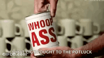 A Person Is Holding A Can Of Whoop Ass Coffee . GIF