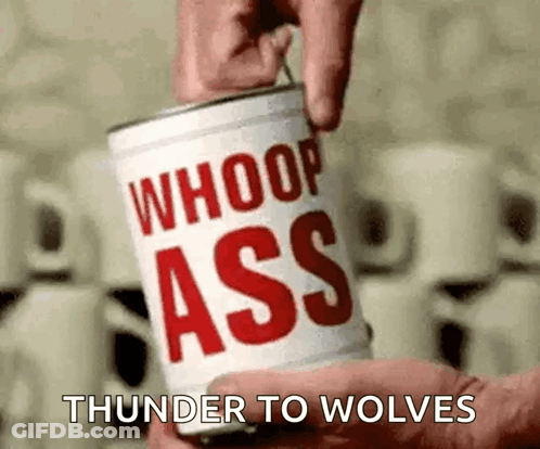 A Person Is Holding A Can Of Whoop Ass Thunder To Wolves . GIF