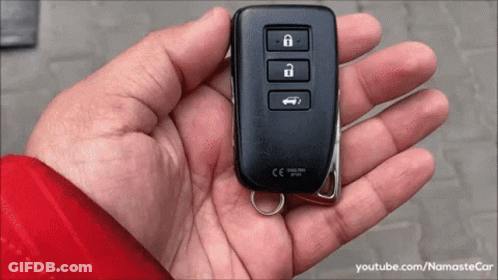 A Person Is Holding A Car Key In Their Hand That Says Ce On It GIF