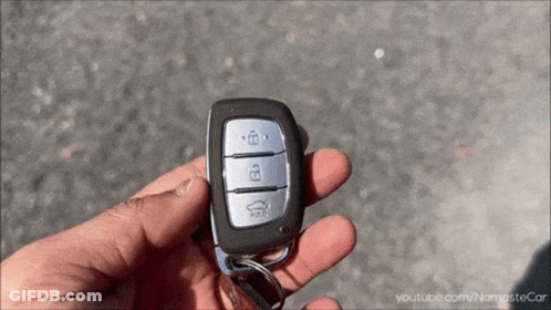 A Person Is Holding A Car Key With Youtube.com/namastecar Written Below It GIF