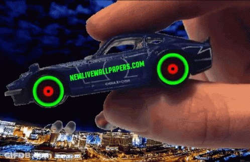 A Person Is Holding A Car That Says Newlivewallpapers.com On It GIF