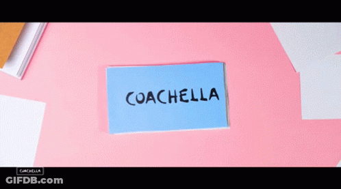 A Person Is Holding A Card That Says Coachella On It GIF
