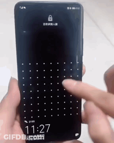 A Person Is Holding A Cell Phone That Says 11:27 On It GIF