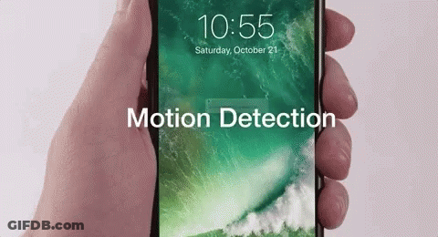 A Person Is Holding A Cell Phone That Says Motion Detection GIF