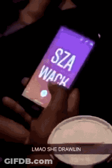 A Person Is Holding A Cell Phone That Says Sza Wack On It GIF