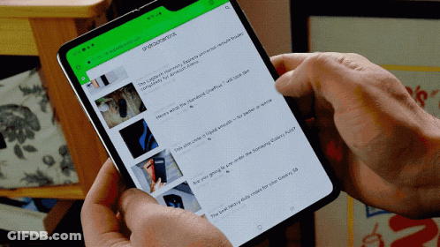 A Person Is Holding A Cell Phone With A Green Screen That Says ' Androidcentral ' On It GIF
