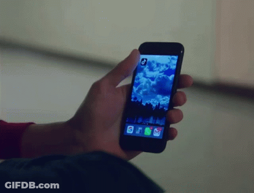 A Person Is Holding A Cell Phone With A Picture Of A Cloudy Sky On The Screen GIF