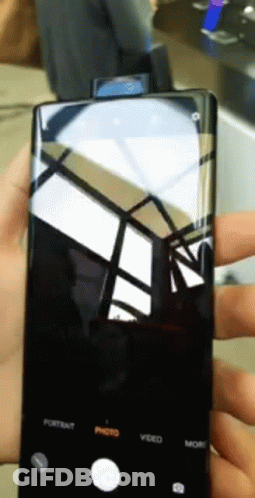A Person Is Holding A Cell Phone With The Portrait Photo Video And More Buttons On It GIF