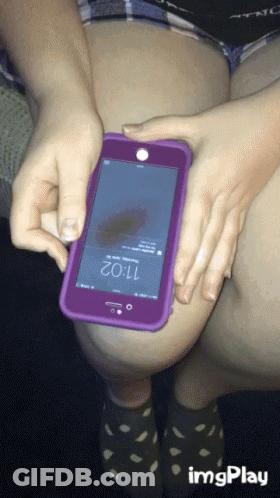 A Person Is Holding A Cell Phone With The Time Of 11:02 On The Screen GIF