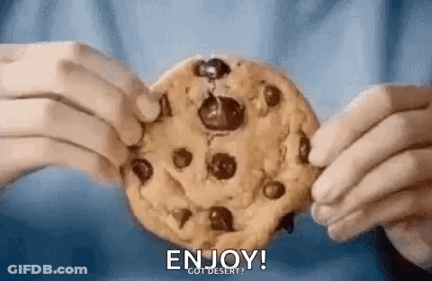 A Person Is Holding A Chocolate Chip Cookie In Their Hands And Saying `` Enjoy ! `` GIF
