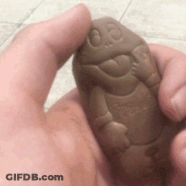 A Person Is Holding A Chocolate Turtle In Their Hand GIF