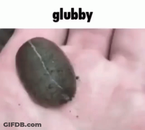 A Person Is Holding A Coffee Bean In Their Hand With The Word Glubby Written Above It GIF