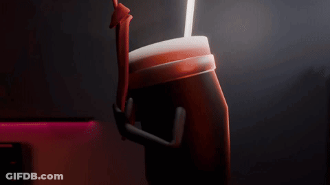 A Person Is Holding A Cup With A Straw In It . GIF