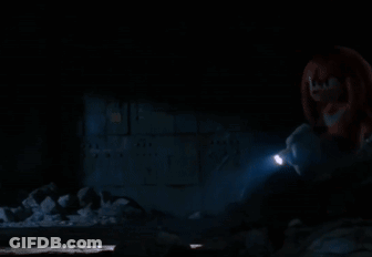 A Person Is Holding A Flashlight In A Dark Room GIF
