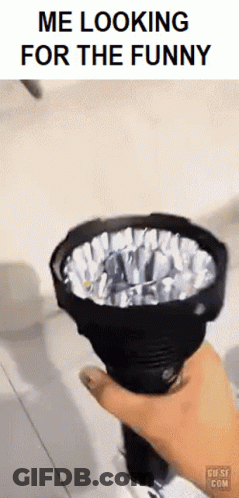 A Person Is Holding A Flashlight In Their Hand With The Caption Me Looking For The Funny . GIF