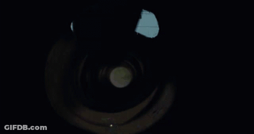 A Person Is Holding A Flashlight Inside Of A Tunnel GIF