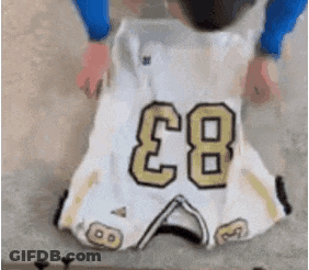 A Person Is Holding A Football Jersey With The Number 83 On It GIF