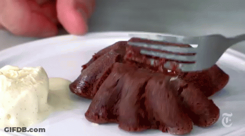 A Person Is Holding A Fork Over A Piece Of Red Velvet Cake On A Plate With Ice Cream . GIF