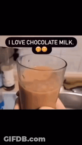 A Person Is Holding A Glass Of Chocolate Milk That Says I Love Chocolate Milk .. GIF