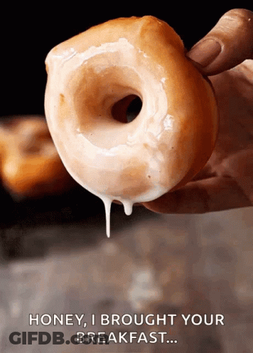 A Person Is Holding A Glazed Donut With The Words Honey I Brought Your Breakfast Above It GIF