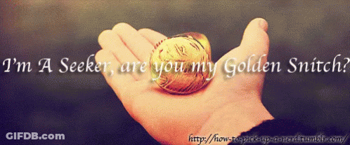 A Person Is Holding A Golden Snitch In Their Hand GIF