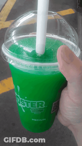 A Person Is Holding A Green Foster Drink With A White Straw GIF