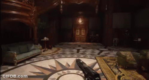 A Person Is Holding A Gun In A Living Room With A Circular Floor . GIF